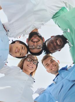 Professional Doctors Holding Each Other Hands. Multinational Medician Meeting. Teamwork Connection. Clinician Team Group. Working Together. Office Friendship. Partnership Arms Shaking.