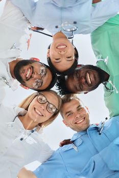 Professional Doctors Holding Each Other Hands. Multinational Medician Meeting. Teamwork Connection. Clinician Team Group. Working Together. Office Friendship. Partnership Arms Shaking.