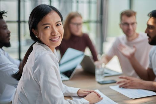 young attractive business lady looking at the camera while sitting at the table