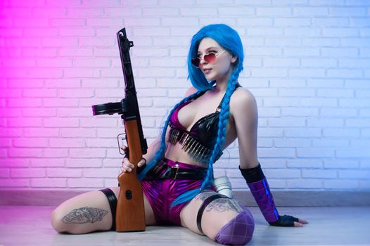 sexy girl in a bright image with a gun in her hands on a neon background