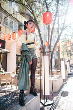 Full length portrait of Asian woman in front of Chinese lanterns