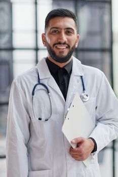 Portrait of male doctor standing with arms crossed