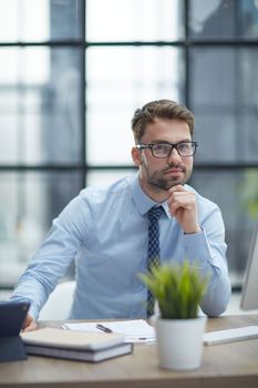 Young cheerful businessman working at office