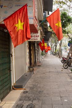 Hanoi, Vietnam, January 2023.  the Vietnamese flags hung along the streets of the city centre