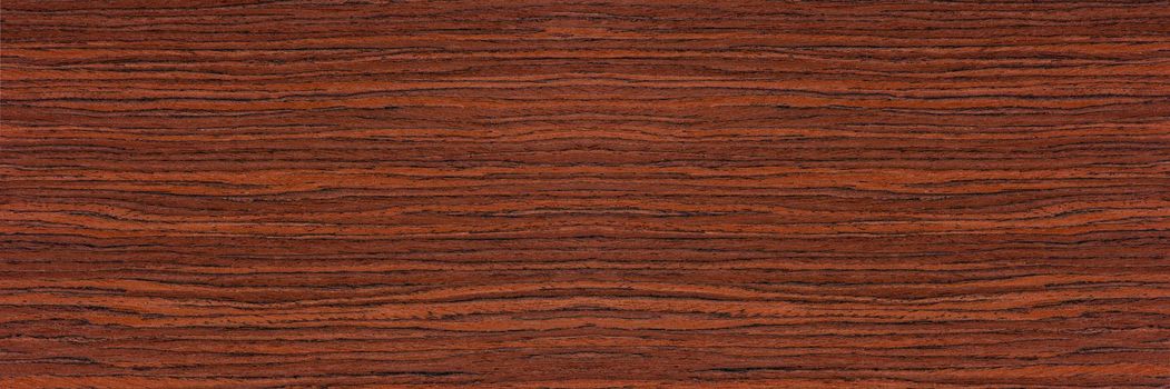 Rosewood texture. Texture of dark mahogany with an intense pattern, natural rosewood veneer for the production of furniture or yacht decoration.