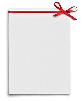 close up of a note card with red ribbon bow on white background