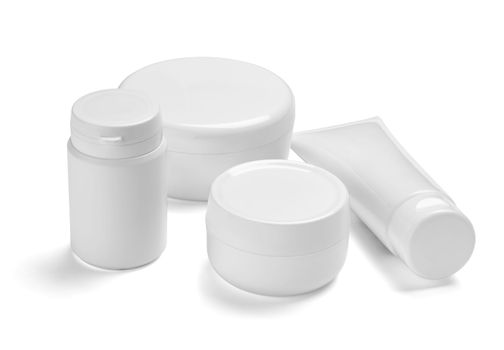 close up of a white beauty cream container and tube on white background