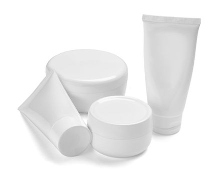 close up of a white beauty cream container and tube on white background