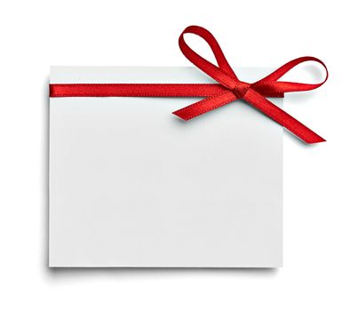 close up of a note card with red ribbon bow on white background