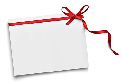 close up of a note card with red ribbon bow on white background