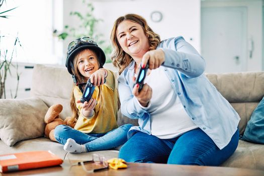 mother and daughter playing and having fun at home