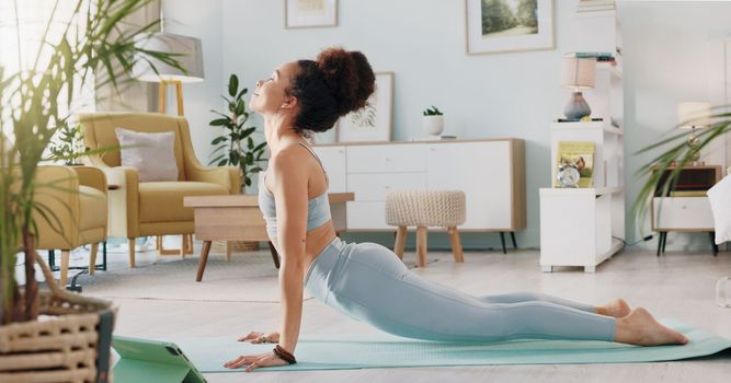 Fitness, yoga or meditation stretching woman for workout in the living room of her house. Girl with chakra focus, mindset or balance while training, exercise or health with zen pilates for wellness