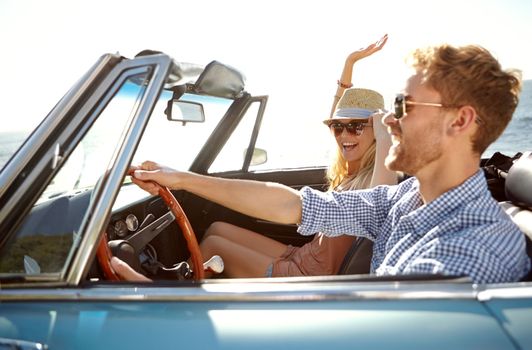 Car road trip, travel and fun couple on bonding holiday adventure, transportation journey or outdoor summer vacation. Love flare, convertible vehicle and driver driving on Australia countryside tour.