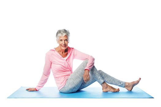 Yoga, portrait and senior woman in studio isolated on a white background. Zen chakra, pilates fitness and retired, elderly and happy female model sitting on mat and training for health and wellness