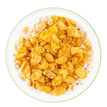 Bowl of sweet cornflakes with milk isolated on white background, top view. Corn flakes with milk splashes isolated on white
