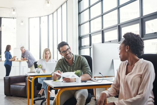 Office, computer and business colleagues talking or in discussion while working on a project in coworking space. Interracial, communication and corporate employees in a conversation in the workplace