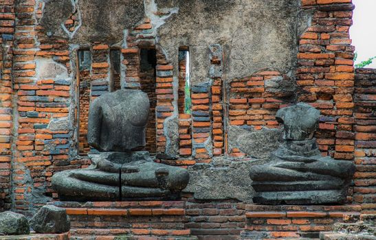 Aytthaya, Thailand, 22 Aug 2020 : Ancient old buddha statue sculpture is damaged at the old temple in Ayuthaya province, thailand. Selective focus.