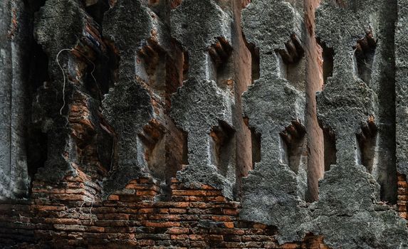 Cracked concrete vintage brick wall background and ventilation holes at the old temple in Ayuthaya. Archaeological area. Pattern on the wall with space for text, No focus, specifically.