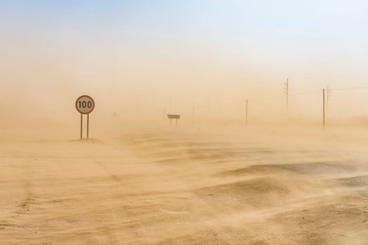 Sandstorm covering the road from Swakopmund to Walvis Bay in Namibia in Africa.