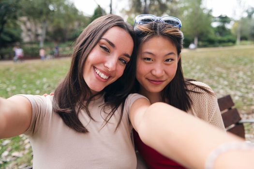selfie photo of two happy young women at park, concept of youth and friendship