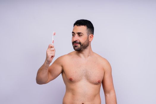 Brush teeth everyday. Masculine model happy to care of oral hygiene, toothbrush, Sanitary conception