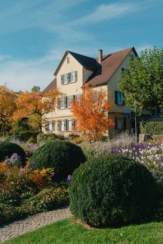 House with nice garden in fall. Flowers in the Park. Bietigheim-Bissingen. Germany, Europe. Autumn Park and house, nobody, bush and grenery