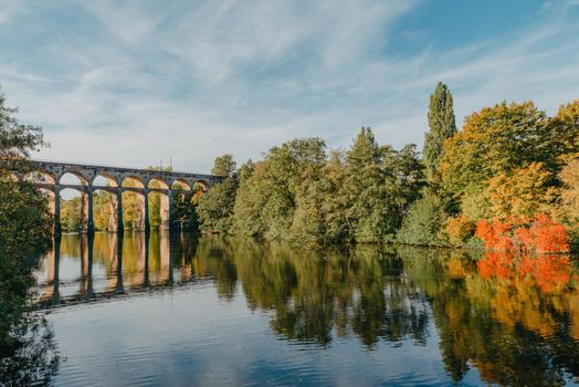 Railway Bridge with river in Bietigheim-Bissingen, Germany. Autumn. Railway viaduct over the Enz River, built in 1853 by Karl von Etzel on a sunny summer day. Bietigheim-Bissingen, Germany. Old viaduct in Bietigheim reflected in the river. Baden-Wurttemberg, Germany. Train passing a train bridge on a cloudy day in Germany