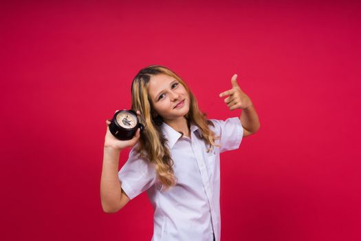 Young Girl holding antique clock over red background