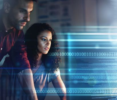 Woman, businessman and computer in night for overlay, futuristic hologram or teamwork for coding strategy. Team, dark office and with holographic tech abstract for focus, pc or information technology.