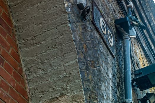 London, UK- Feb 24, 2019 : The pigeon is on the pipe in front of the warehouse under the bridge.