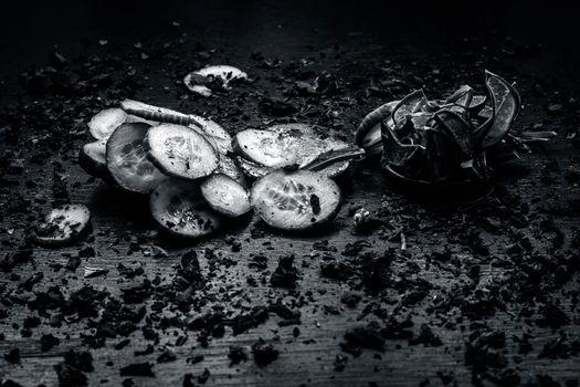 Close-up of ingredients of facial or face pack or face mask on a wooden surface i.e. slices of cucumber and Aloe Vera in dark Gothic colors for brightening and softening the skin.