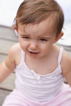 Shes not impressed...An unhappy little girl standing outside