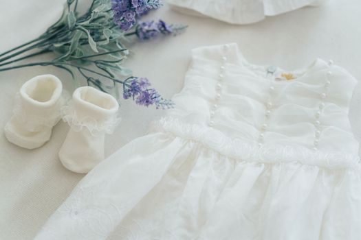 baby clothes for a newborn girl, slippers and white dress