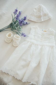 baby clothes for a newborn girl, slippers and white dress