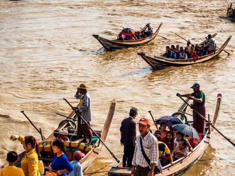 Yangon, Myanmar - Jan 4, 2020 People and tourists boarding a small boat, The only way to get to the Kyaik Hwaw Wun Pagoda and temple on a small island in the river at Kyauktan town, Yangon, Myanmar