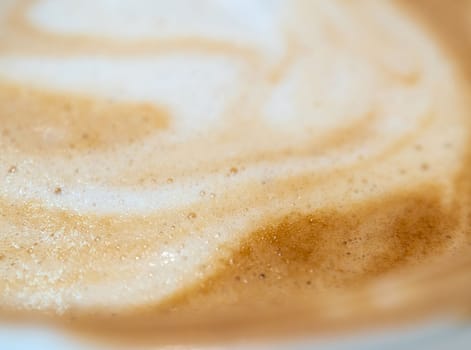 Full-frame close-up texture surface of soft and delicate milk froth in a cup of coffee