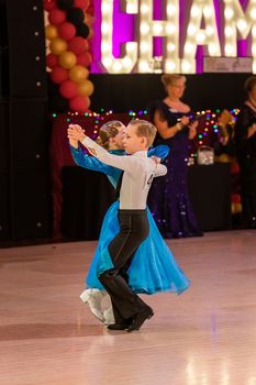 Attractive young couple of children dancing ballroom dance. Girl and boy dancer latino international dancing.