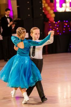 Attractive young couple of children dancing ballroom dance. Girl and boy dancer Latino international dancing.