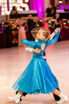 Attractive young couple of children dancing ballroom dance. Girl and boy dancer Latino international dancing.