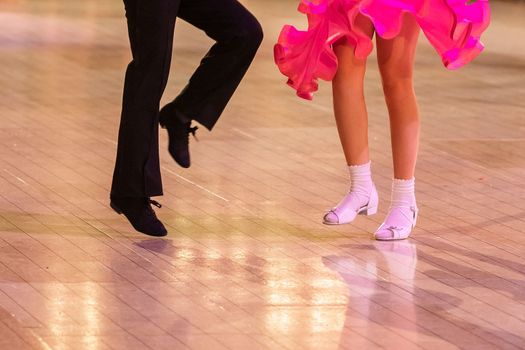 Attractive young couple of children dancing ballroom dance. Girl and boy dancer Latino international dancing.