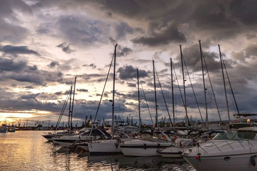 Yachts and boats after sunset in the harbor. Black sea, Varna, Bulgaria.