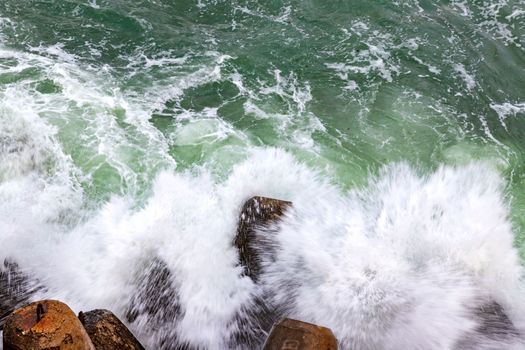 Sea waves smashed on rocks. Top view