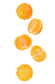 Isolated flying grapes. Five whole and sliced mandarin fruits falling on white with clipping path as package design element and advertising. Full depth of field.