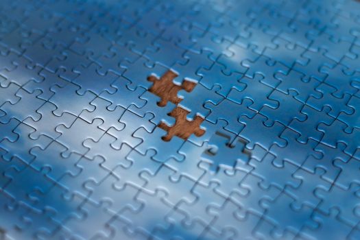 The missing piece of the sky puzzle, the concept of completing a big job, the final of the project, the successful solution of business problems. The hand puts the last piece of the jigsaw