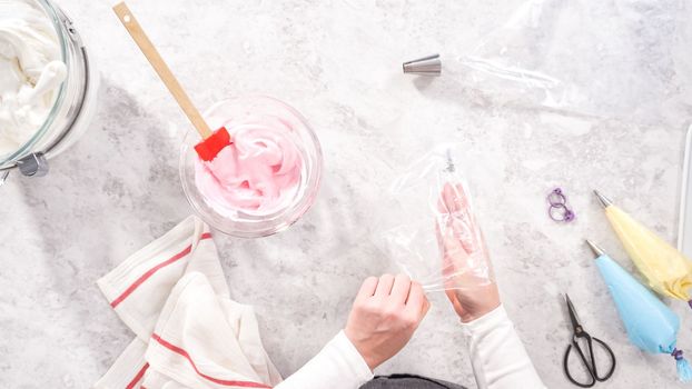 Flat lay. Step by step. Transfering meringue mix into piping bags with metal tips to bake unicorn meringue pops cookies.