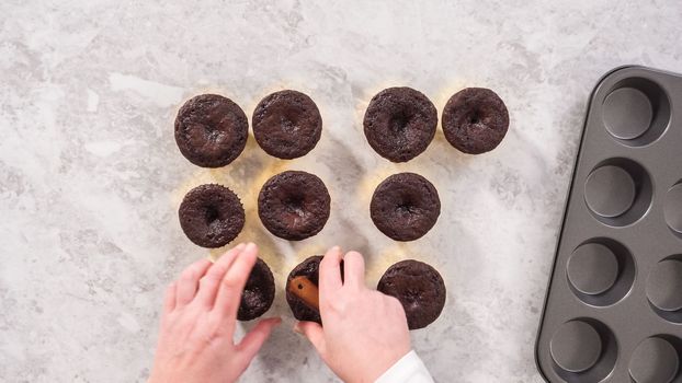 Flat lay. Step by step. Cooling freshly baked chocolate cupcakes to be decorated with buttercream frosting.