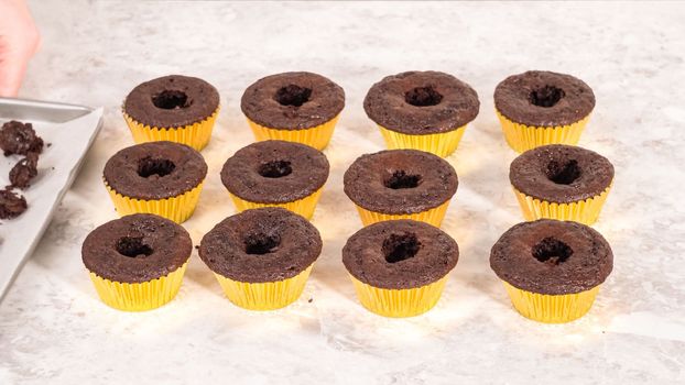 Step by step. Filling in chocolate cupcakes with chocolate ganache.