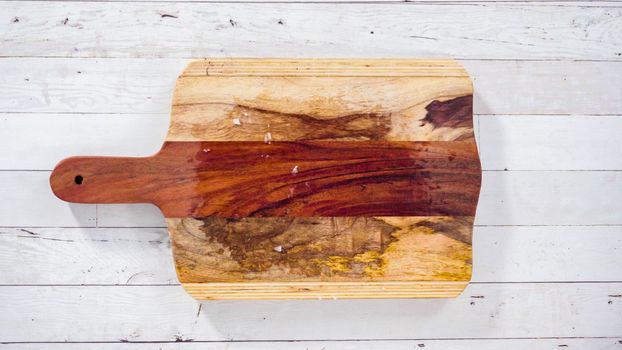 Flat lay. Empty rustic wooden cutting board with kitchen knife.