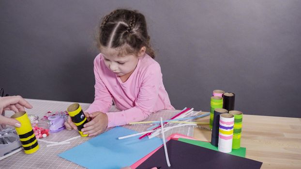 Kids papercraft. Making paper bugs out of the empty toilet paper rolls and construction paper.