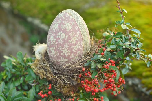 Easter egg in nest at a garden.
